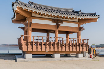 Fototapeta premium Wooden pavilion in alcove of concrete pier in small port near Pyeongtaek, South Korea.