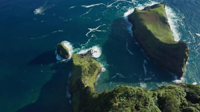 Casa do Gato Tomas, Flores Island, Azores, Portugal. Picturesque sunrise during low tide. Aerial view of the shore covered with lush green vegetation. High quality 4k footage