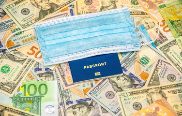 Medical mask and banknotes of the countries of the world. Travel and business during the coronavirus pandemic