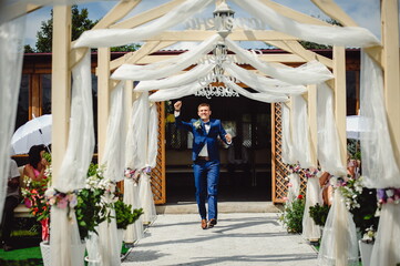 Stylish groom in tuxedo at wedding ceremony. Portrait of happy groom.