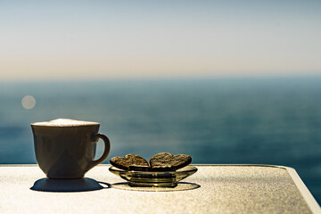 Coffee cup on sea shore. Travel outdoor picnic.