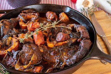 Braised beef shanks in a cast iron pan