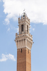 Fototapeta premium View of Torre del Mangia medieval tower, located in Piazza del Campo, it is one of the most iconic landmark of Siena, Italy