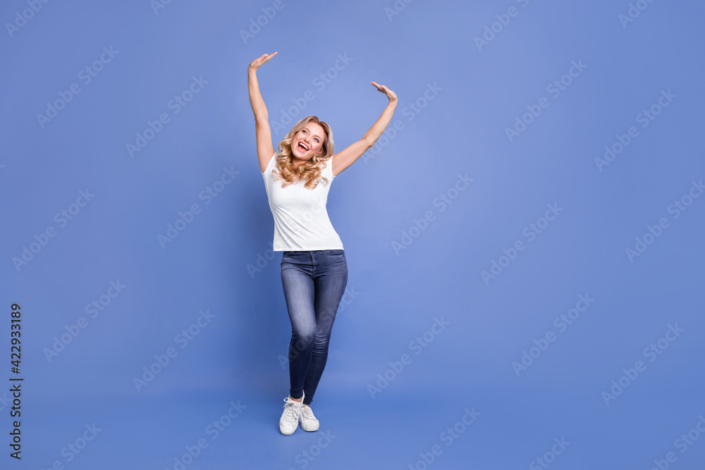 Wall mural full body photo of young excited woman happy positive smile enjoy rejoice look empty space isolated 