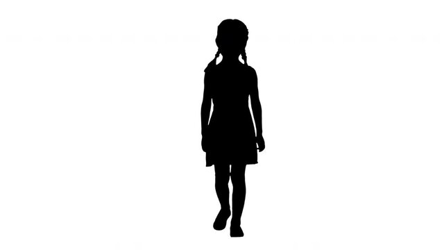 Silhouette Little girl in polka dot dress with pig tails walking and smiling shyly to the camera.
