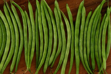 Fresh green beans on wooden background.
