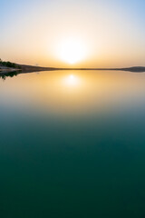 Beautiful sunset at the Störmthaler lake with a calm water surface