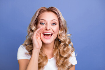 Fototapeta premium Photo of young happy smiling positive funky funny girl hold hand mouth telling rumors isolated on blue color background