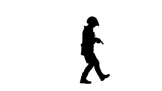 Silhouette Police SWAT armed fighter walking with a hand gun.
