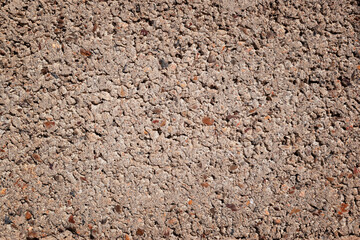 Close up on red or gray wall texture. Gravel with cement pattern.  Wall composed of small stones that can be used as a background, wallpaper or shelf. Old building and construction wall designs.