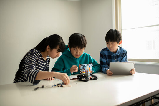 Elementary School Students Assembling Programming Robot