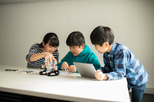 Elementary School Students Assembling Programming Robot