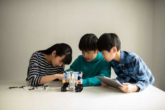 Elementary School Students Assembling Programming Robot
