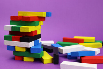 Tower game and scattered colored wooden blocks