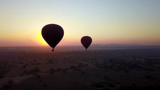 Powerful Sunrise Behind Hot Air Balloons at Bagan, Myanmar or Burma, Aerial