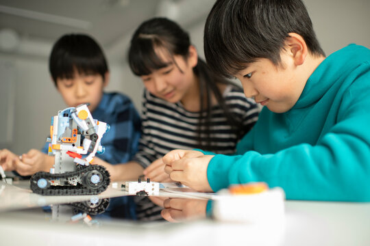 Elementary School Students Assembling Programming Robot