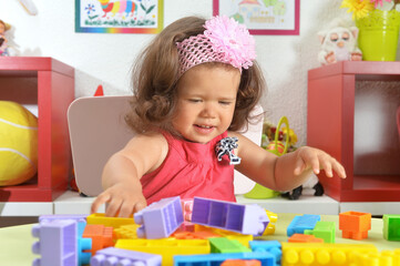 Fototapeta na wymiar cute little baby girl with toys