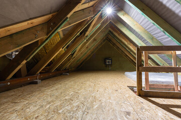 Fototapeta na wymiar The attic of a single family house with a wooden floor