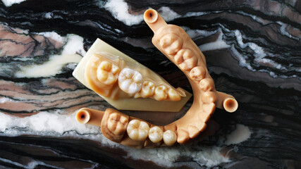 beautiful composition of zircon crowns on models, top view on marble stone