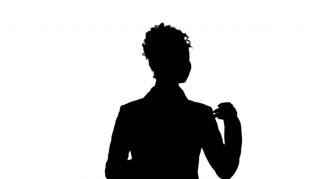 Silhouette African American lady in a suit pointing at blank spaces.