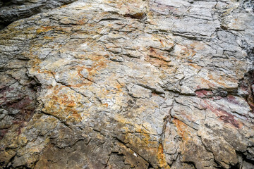 .Colorful rock rock texture, geological phenomenon in the rocks above the atlantic ocean.