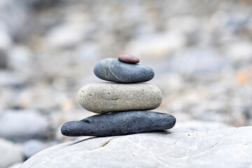 A background of pebbles by the ocean on the beach, a symbol of peace and relaxation.