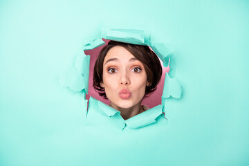 Photo of nice optimistic brunette lady blow kiss broke wall isolated on teal color background