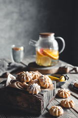 Tasty cakes with Hot tea with slices of fresh grapefruit on wooden tablet. Healthy drink, Eco, vegan
