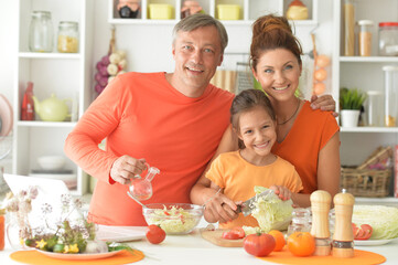 family cooking together at kitchen table