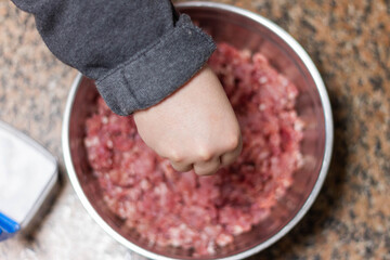Girl salting the mince