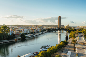 Obraz premium Panoramic view of Guadalquivir River with Triana and Seville Tower, Spain