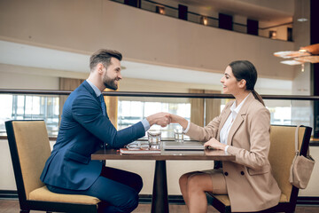 Obraz premium Young woman in a beige suit having an interview with a manager
