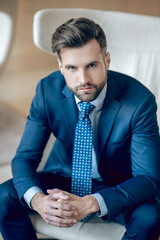 Young bearded man in a nice blue suit and tie