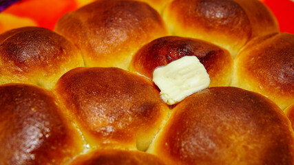 homemade cakes. homemade buns and a piece of butter on top.