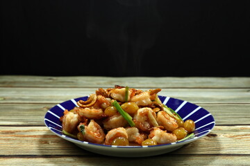 Traditional fried mixed fresh peeled shrimp with gingko, cashew nut and baked almond serving on the plate. 