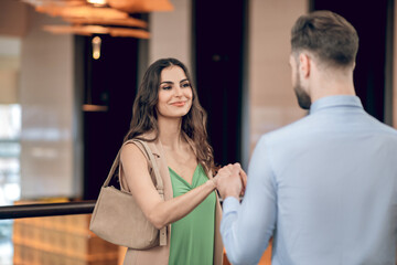 Man and woman meeting in the restaurant and looking excited
