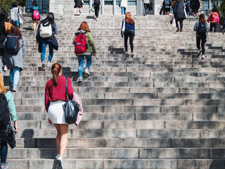 Asian Women walking on stair-step outdoor building Campus life Asian Student