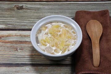 Traditional small season cake made of flour boiled in coconut milk serving in the bowl. Famous sweet dessert in Thai restaurant.