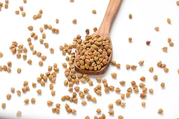 Dry raw organic chickpeas in a wooden spoon isolated on white background.