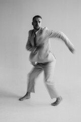 Portrait of a dancing guy with blurred background and long exposure. Black and white photography