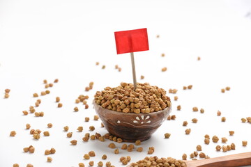 Dried chickpeas in bowl isolated on white background.