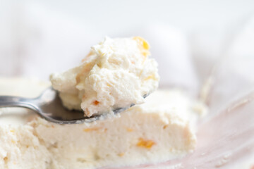 delicious soft cottage cheese with dried apricots on a teaspoon