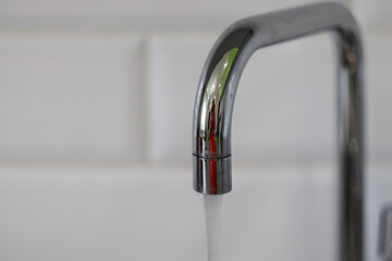 chrome water tap in the kitchen close-up