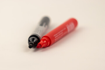 red and black felt-tip pen on a sheet of white paper