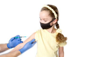 A nurse is giving vaccinations to patients with a syringe. A doctor vaccinates a teenage girl in a...