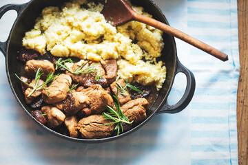 Teriyaki pork loins in whiskey, coffee and rosemary sauce, served with couscous and salad