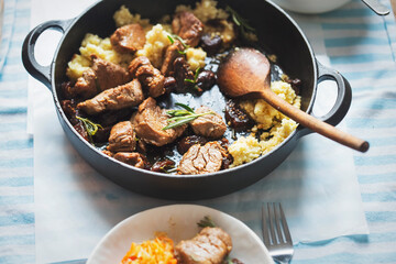 Teriyaki pork loins in whiskey, coffee and rosemary sauce, served with couscous and salad