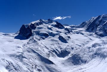 Snow capped mountains, snowfields and glaciers at Zermatt, Switzerland, seen from Gornergrat railway station.