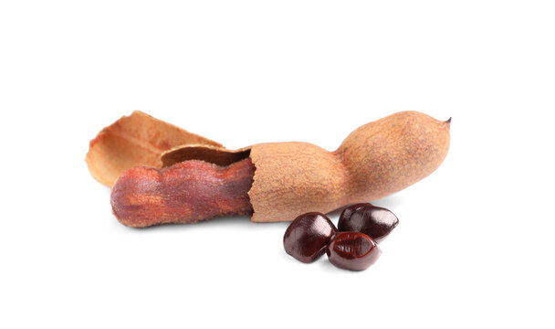Delicious ripe tamarinds and seeds on white background. Exotic fruit