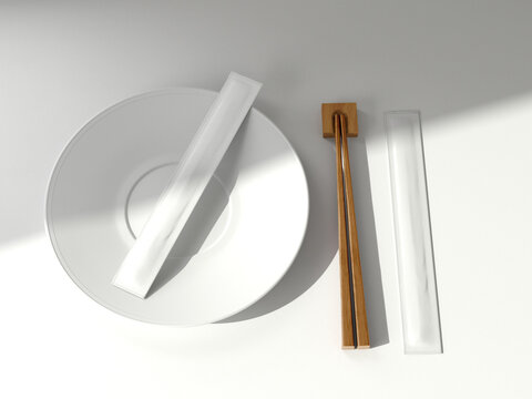 Two Plain White Chopsticks Packaging on Plate with wooden chopsticks on isolated background